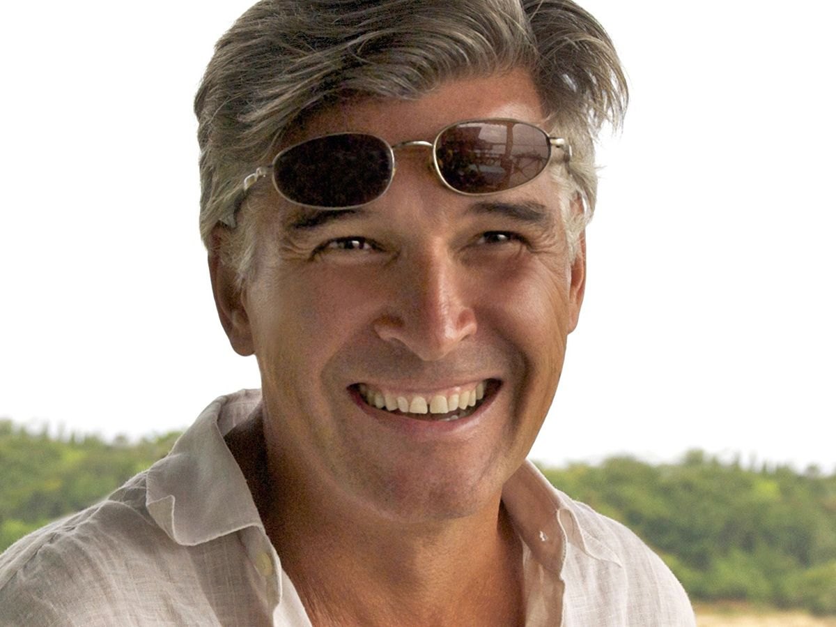 Portrait of Gian Paolo Tomasi smiling outdoors, sunglasses on his head