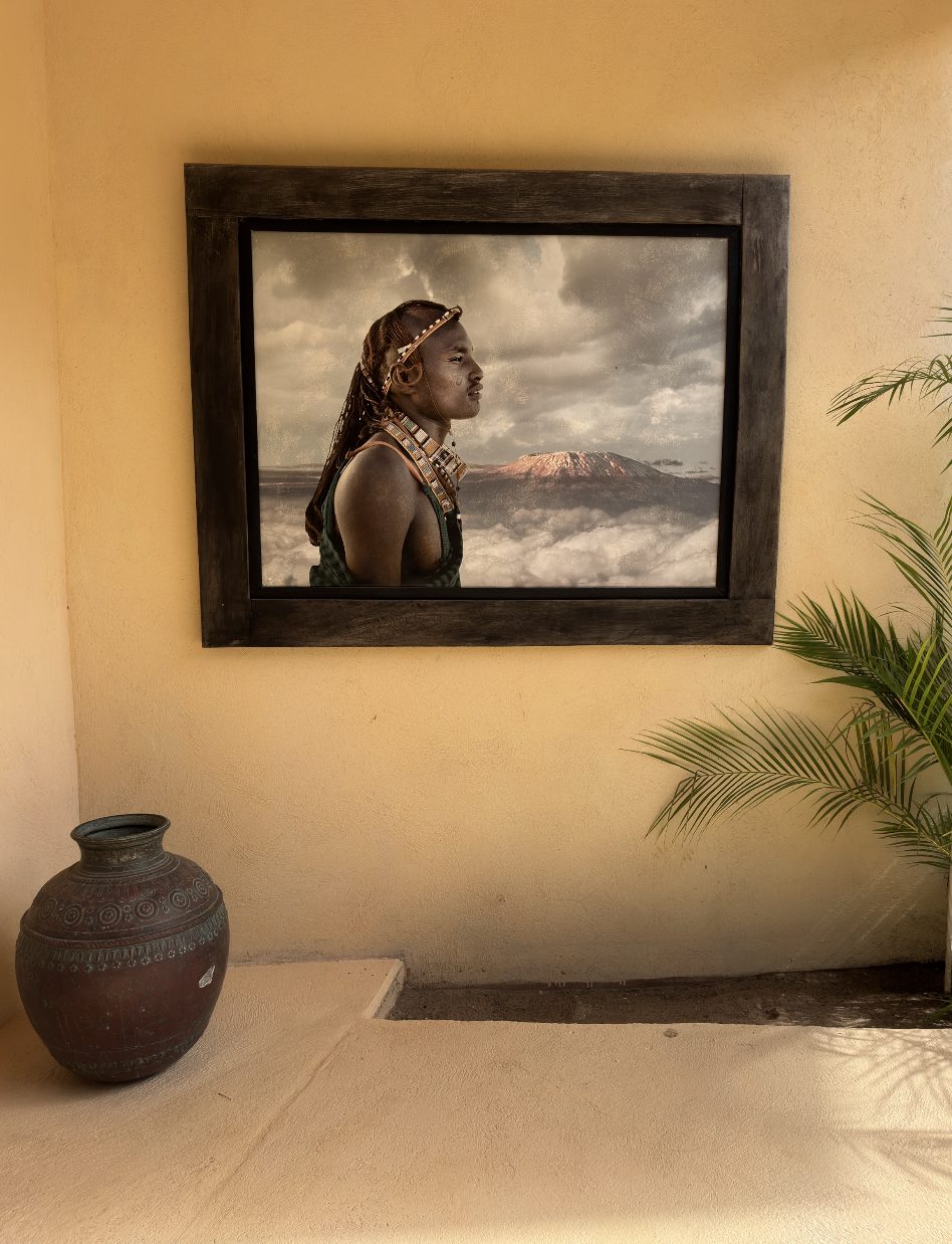 Maasai profile with Kilimanjaro, framed on an ochre wall