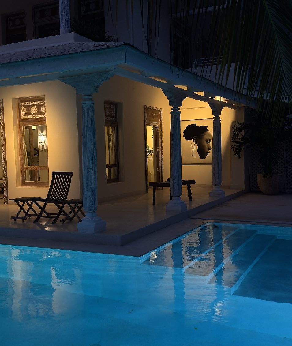 Portrait shaped like Africa on a veranda beside the pool at night