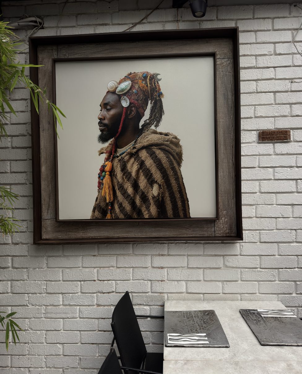 Profile of a man with a shell headdress above a dining table